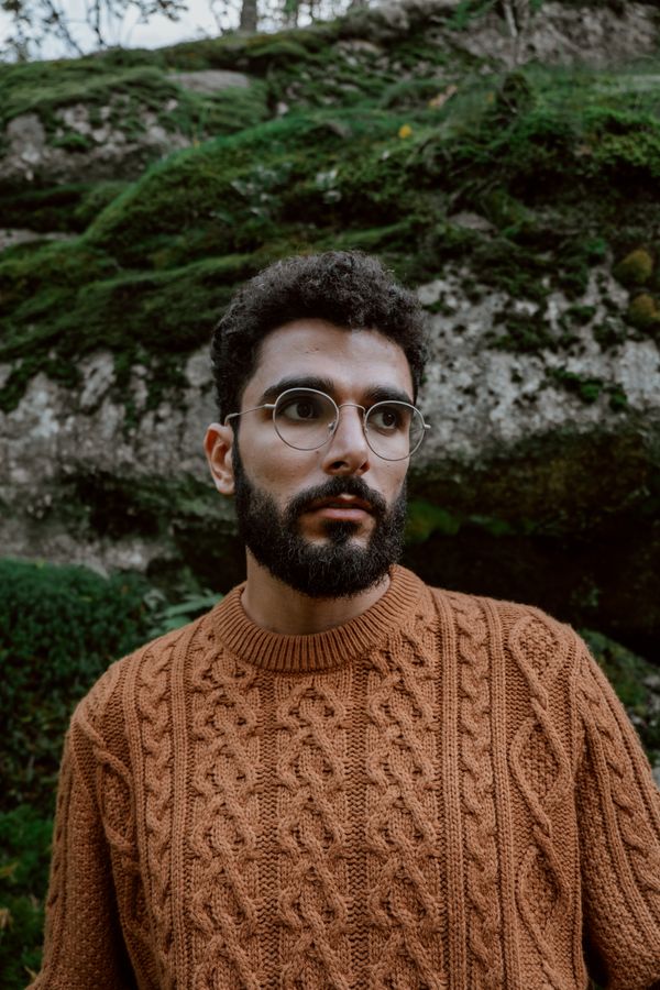 Mann in einem rostfarbenen Strickpullover